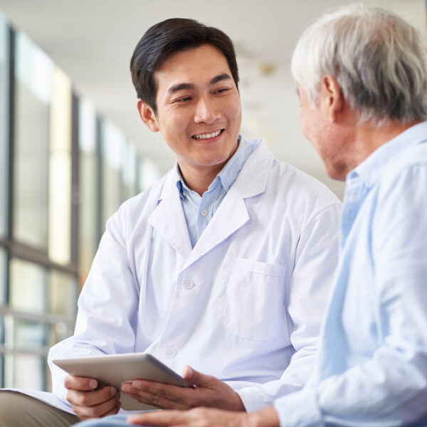 Doctor looking and speaking with patient.