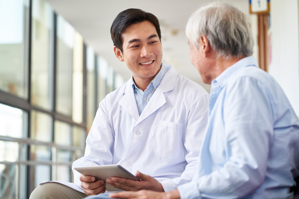 Doctor looking and speaking with patient.