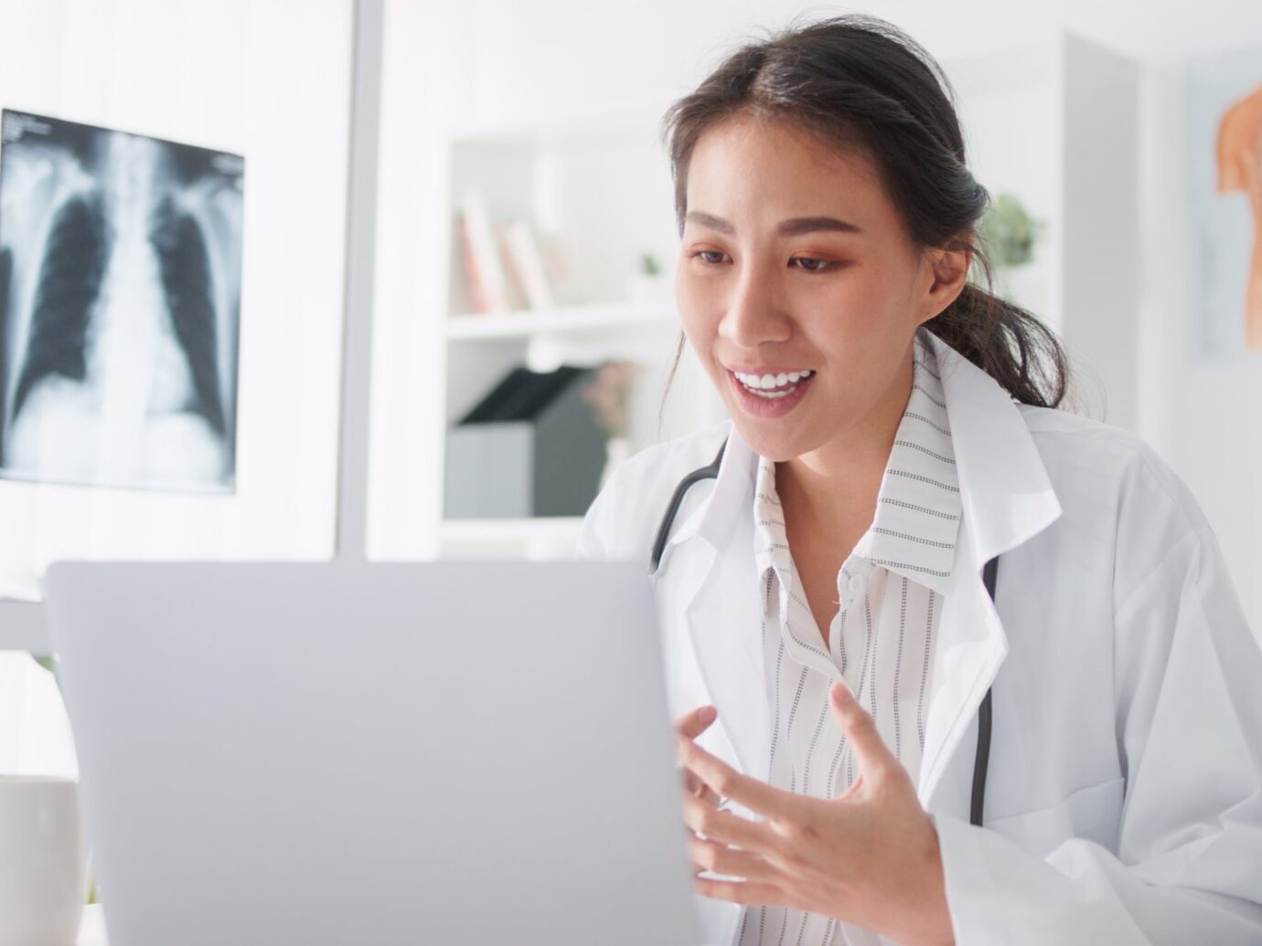 Provider sitting at desk speaking to computer.