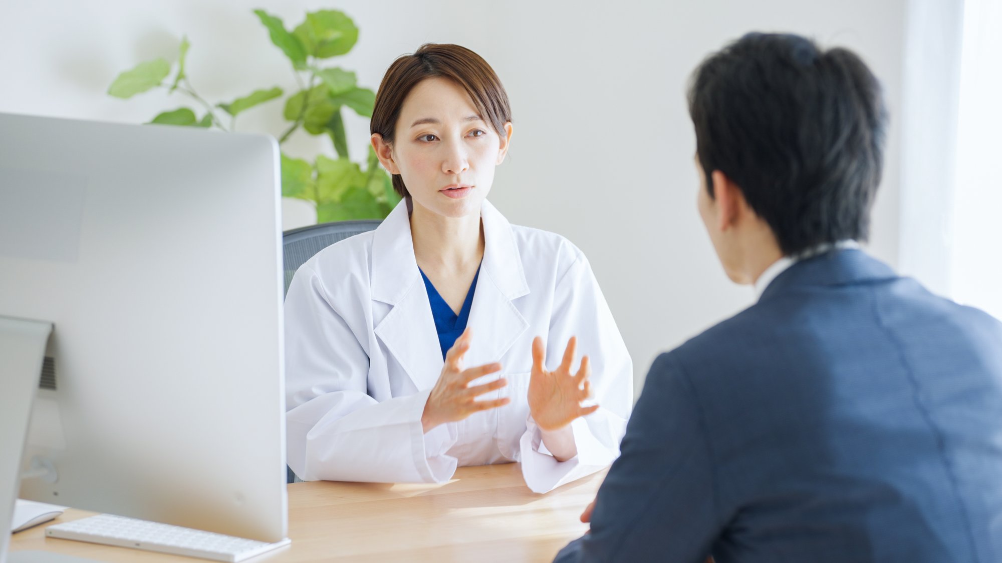 Provider sitting at desk talking to someone.