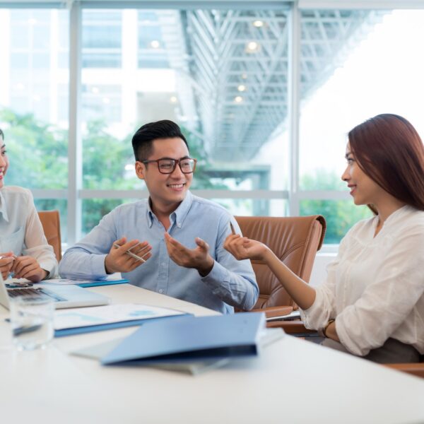 Group of people talking around a table.